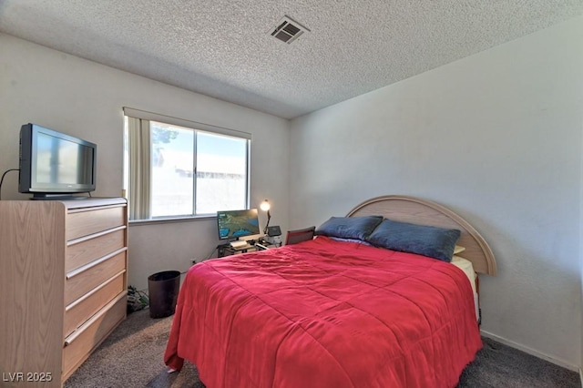 bedroom featuring a textured ceiling, carpet floors, visible vents, and baseboards