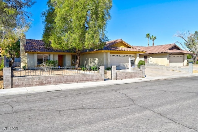 ranch-style home featuring a garage, concrete driveway, a fenced front yard, a tiled roof, and stucco siding