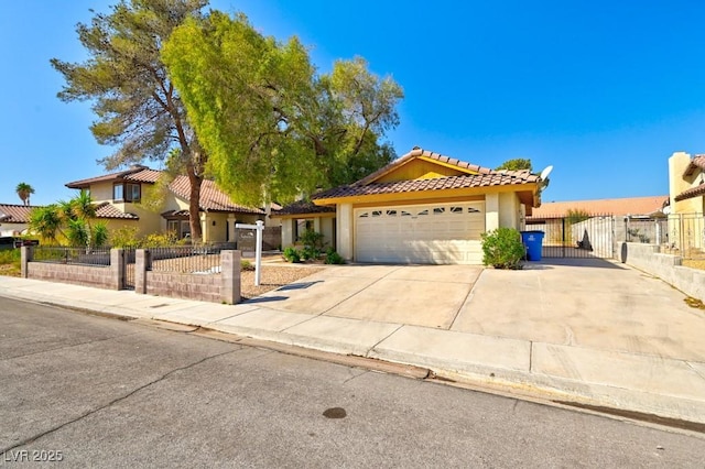 view of front of house with a garage, a gate, fence, and driveway