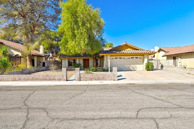 view of front facade featuring a garage, driveway, a fenced front yard, and stucco siding