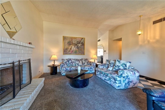 living room featuring lofted ceiling, a textured ceiling, a fireplace, visible vents, and carpet