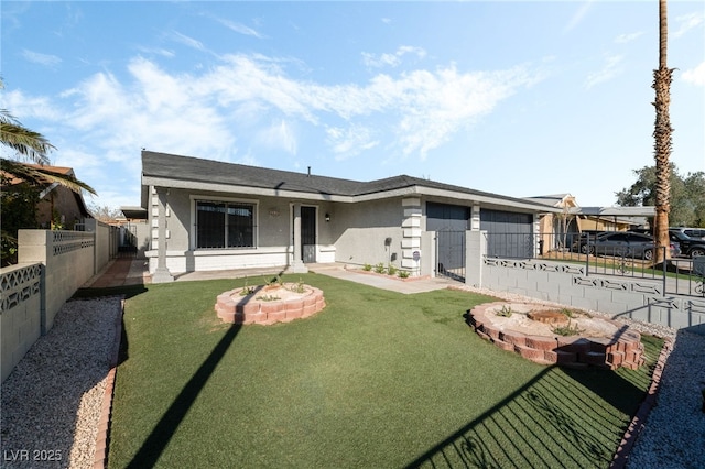 view of front of home featuring a front lawn, fence private yard, an attached garage, and stucco siding