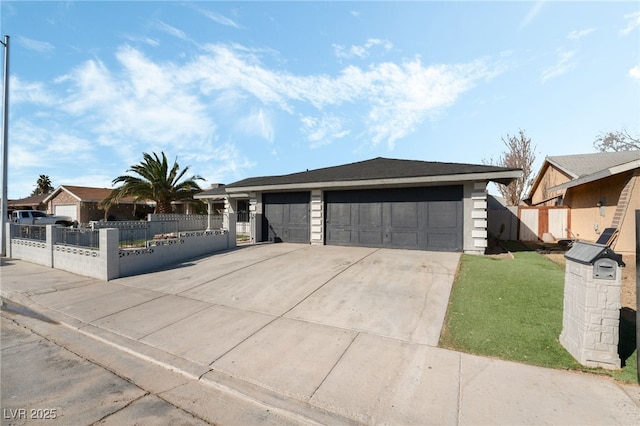 view of front of house with driveway, a fenced front yard, and a garage