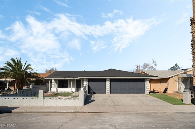 ranch-style home with a garage, concrete driveway, and a fenced front yard