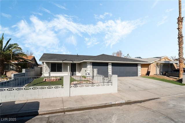 ranch-style house featuring a garage, driveway, and a fenced front yard