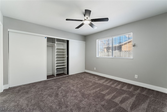 unfurnished bedroom with a closet, carpet, a ceiling fan, and baseboards