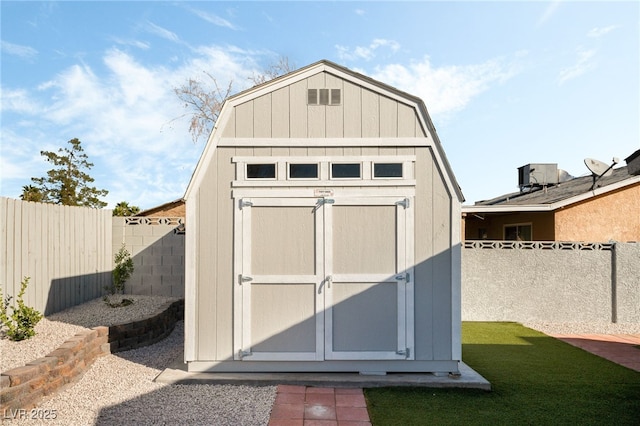 view of shed featuring a fenced backyard and cooling unit