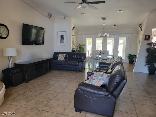 living area with light tile patterned floors, visible vents, ornamental molding, and ceiling fan with notable chandelier