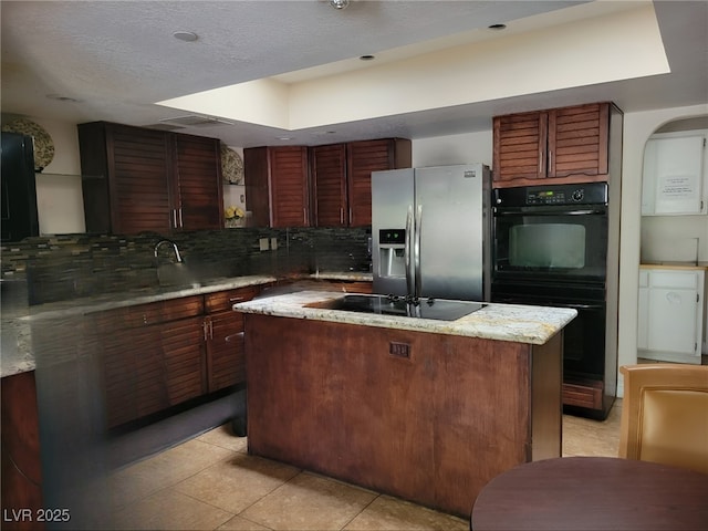 kitchen featuring a center island, open shelves, decorative backsplash, light tile patterned flooring, and black appliances