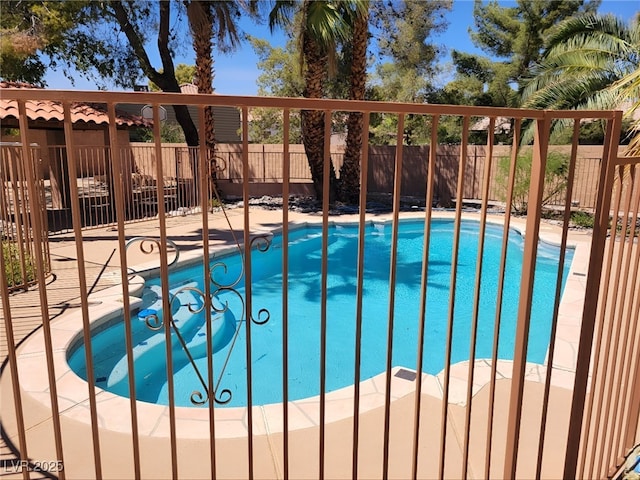 view of swimming pool with a fenced backyard