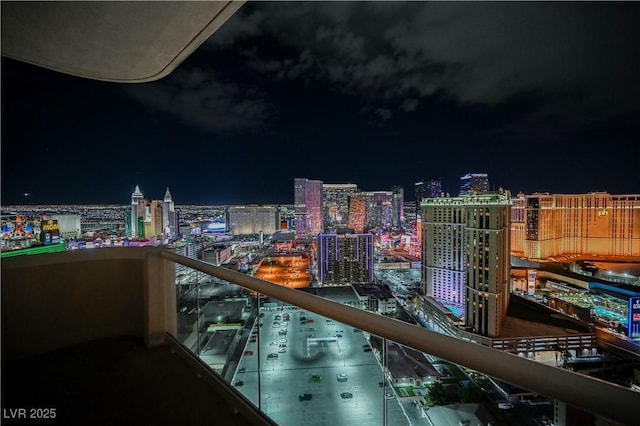 balcony at twilight featuring a view of city lights