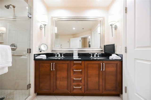 bathroom with a stall shower, a sink, and double vanity