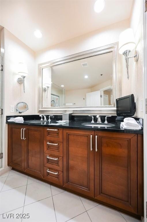 bathroom featuring double vanity, a sink, and tile patterned floors