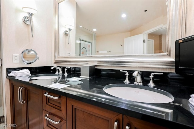 bathroom with double vanity, a sink, and recessed lighting