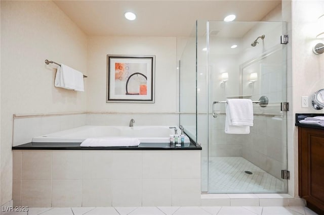 full bathroom with a stall shower, vanity, a bath, and recessed lighting