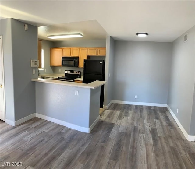 kitchen with black appliances, baseboards, wood finished floors, and light brown cabinetry