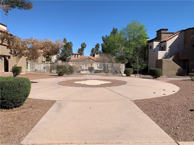 view of home's community featuring driveway, a residential view, and fence