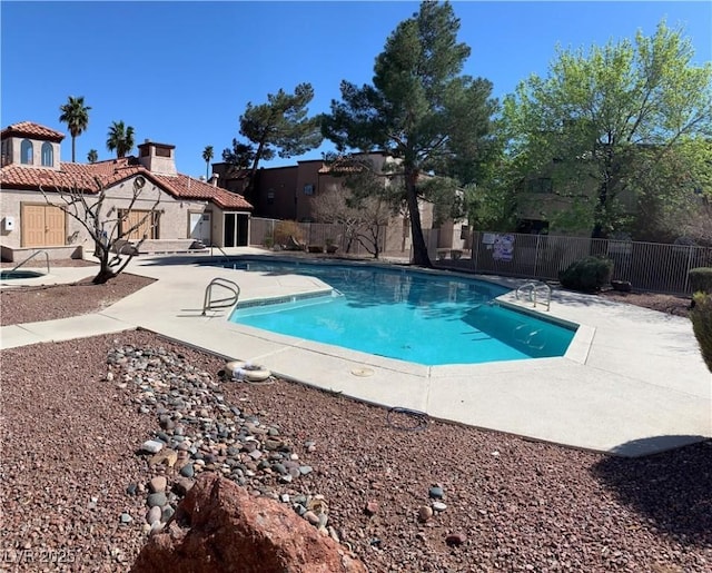 pool featuring a patio area and fence