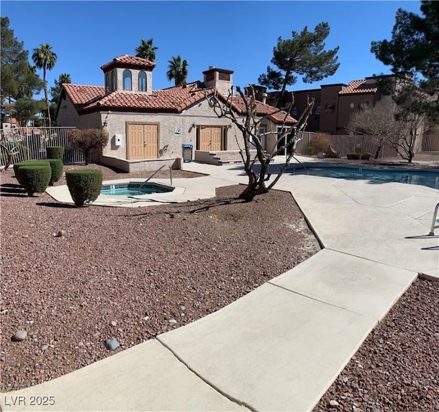 exterior space with a fenced in pool, a tile roof, stucco siding, a patio area, and fence