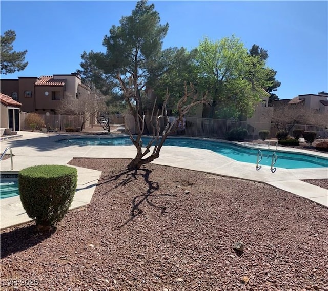 pool featuring a patio area and fence