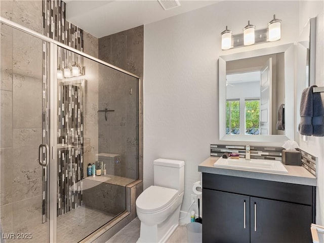 full bathroom featuring visible vents, toilet, a stall shower, and vanity