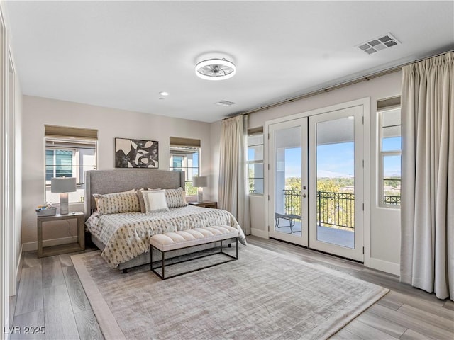 bedroom featuring visible vents, multiple windows, french doors, and access to outside