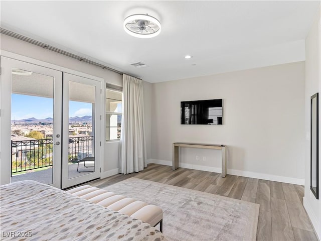 bedroom featuring visible vents, access to outside, wood finished floors, french doors, and baseboards