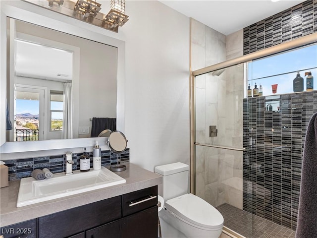 full bath featuring a shower stall, toilet, and vanity