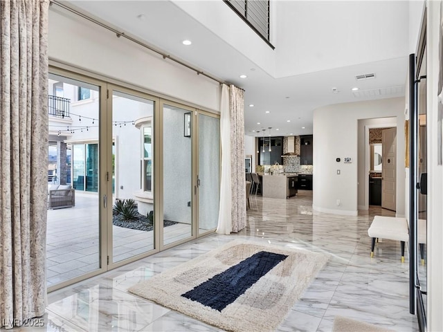 entryway featuring recessed lighting, visible vents, a high ceiling, and marble finish floor