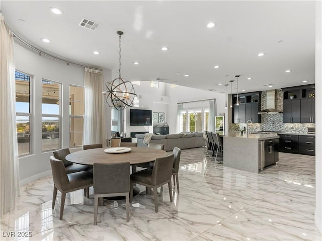 dining room with a notable chandelier, recessed lighting, visible vents, and marble finish floor