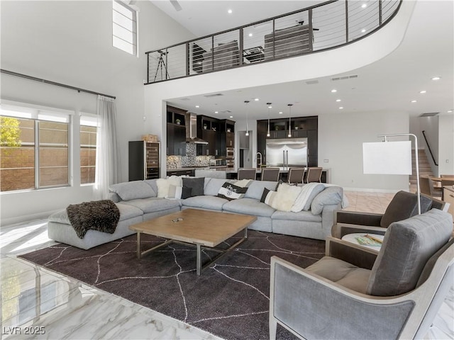 living area with visible vents, baseboards, stairs, recessed lighting, and marble finish floor