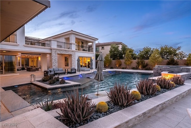 view of swimming pool featuring a fenced in pool, fence, an in ground hot tub, outdoor lounge area, and a patio area