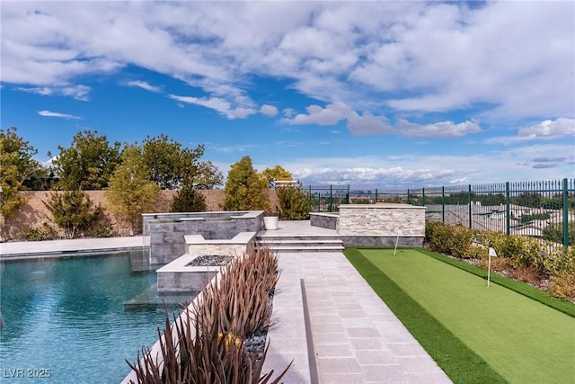 view of community with an outdoor fire pit and fence