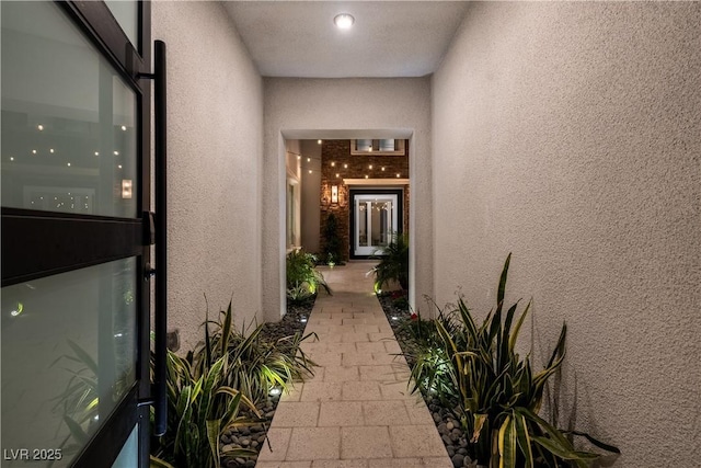 view of exterior entry with stucco siding