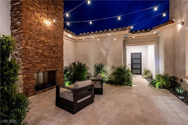 view of patio / terrace featuring an outdoor stone fireplace