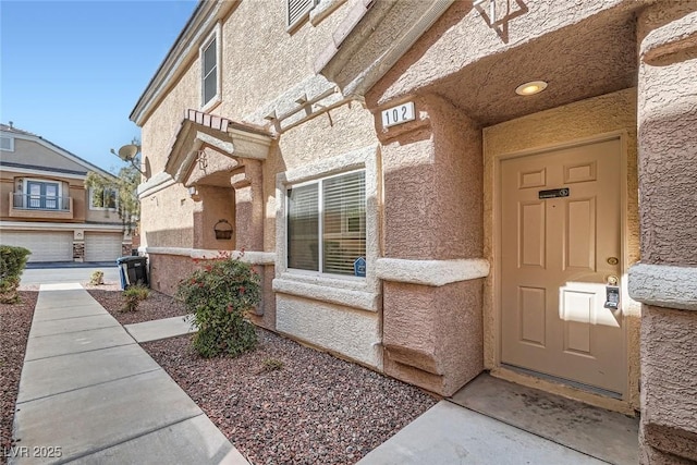 entrance to property with stucco siding