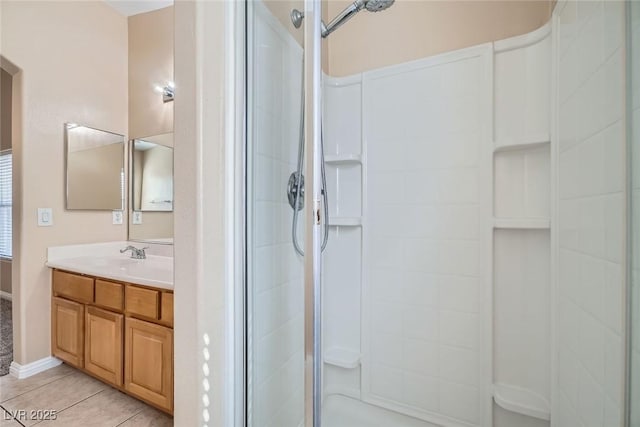 full bath with a stall shower, vanity, and tile patterned floors