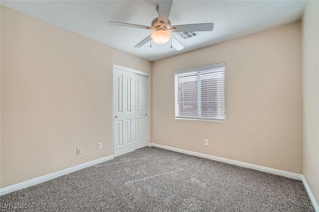 unfurnished room with baseboards, visible vents, ceiling fan, and carpet flooring