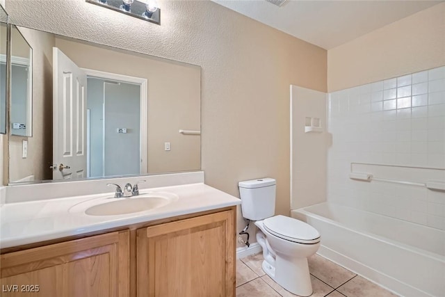 full bath featuring vanity, shower / washtub combination, tile patterned flooring, and toilet