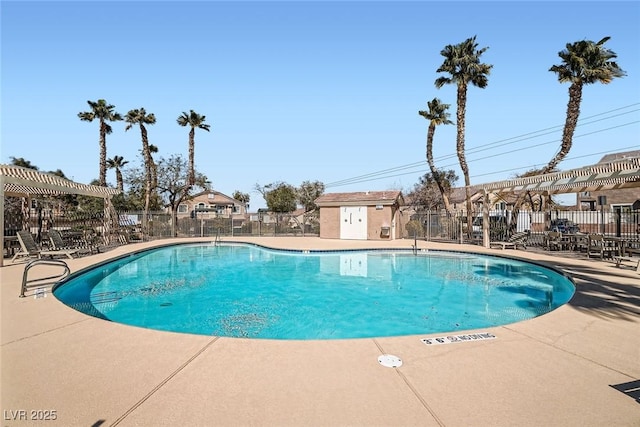 community pool with a patio area, fence, and a pergola