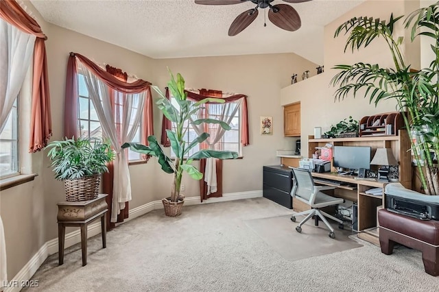 home office with a textured ceiling, ceiling fan, lofted ceiling, light colored carpet, and baseboards