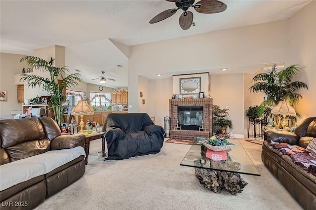 living room with carpet floors, a fireplace, vaulted ceiling, and a ceiling fan