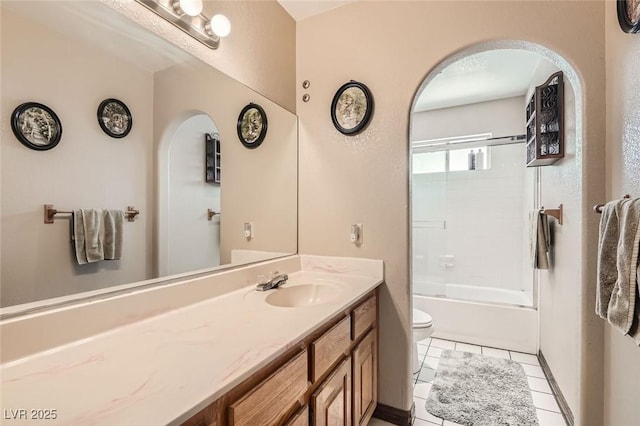 full bathroom featuring bath / shower combo with glass door, vanity, toilet, and tile patterned floors