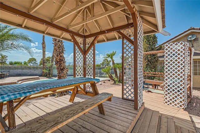 wooden terrace featuring outdoor dining area and fence