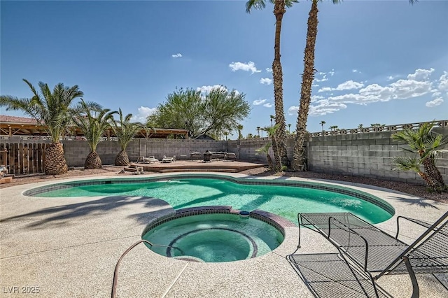 view of pool featuring a pool with connected hot tub, a fenced backyard, and a patio