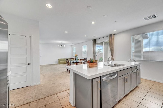 kitchen featuring light carpet, light tile patterned floors, light countertops, gray cabinetry, and a sink