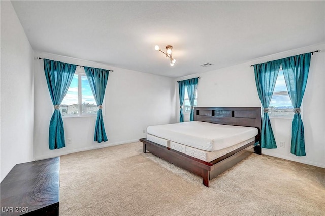 bedroom featuring baseboards, visible vents, and carpet flooring