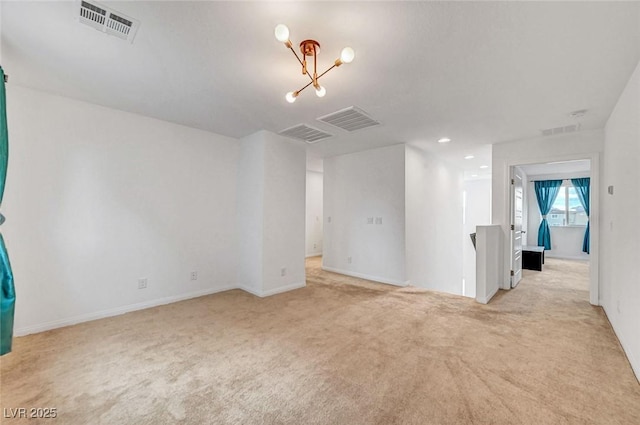 spare room with recessed lighting, visible vents, and light carpet