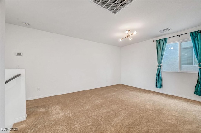 carpeted spare room featuring visible vents