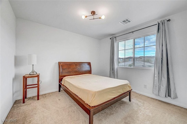 carpeted bedroom featuring baseboards and visible vents